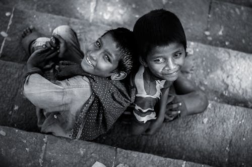 High Angle Shot of a Two Boys Sitting on the Floor