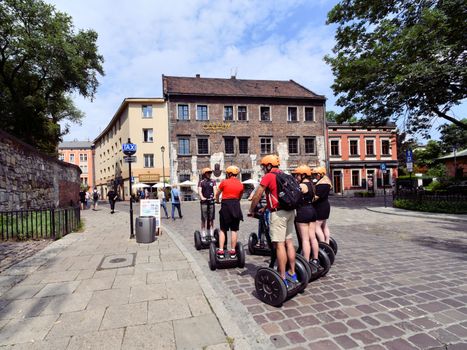 People Riding Segway on the Street