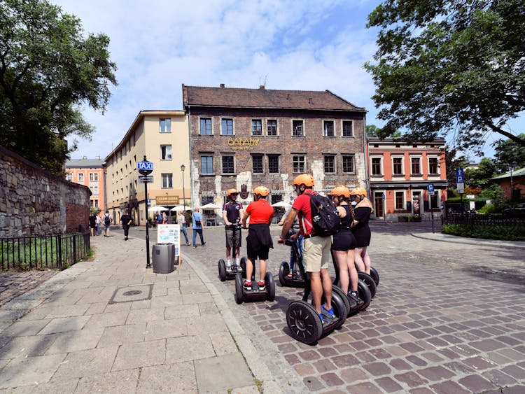 People Riding Segway On The Street