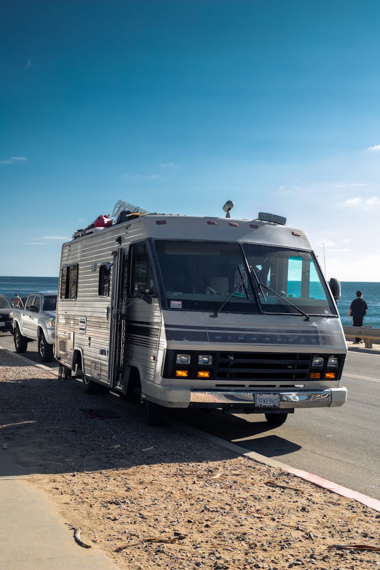 White RV Trailer On Gray Asphalt Road