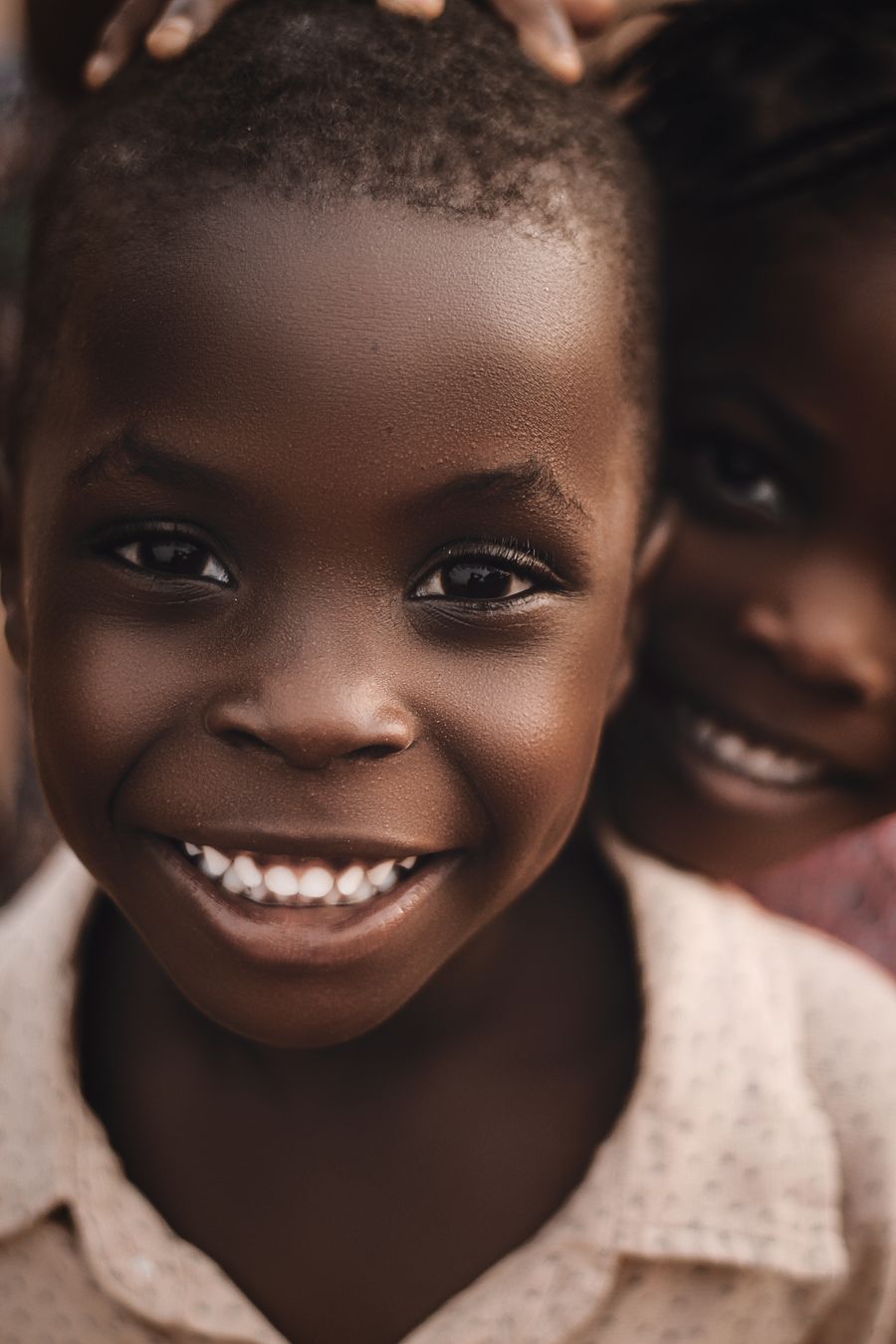 A child smiling outdoors