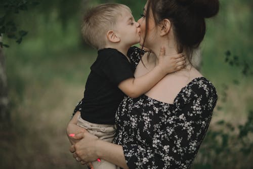 A Kid Kissing His Mother