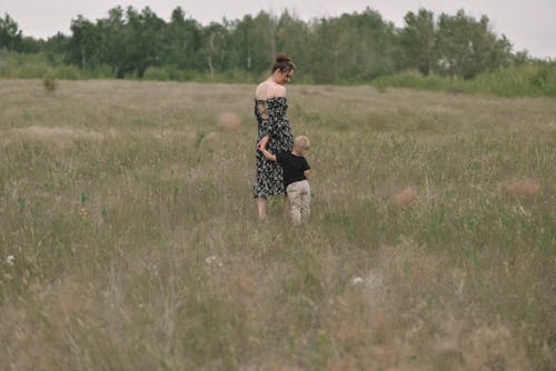 A Woman With Her Son on a Grass Field 