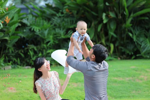 A Man Lifting a Baby Boy