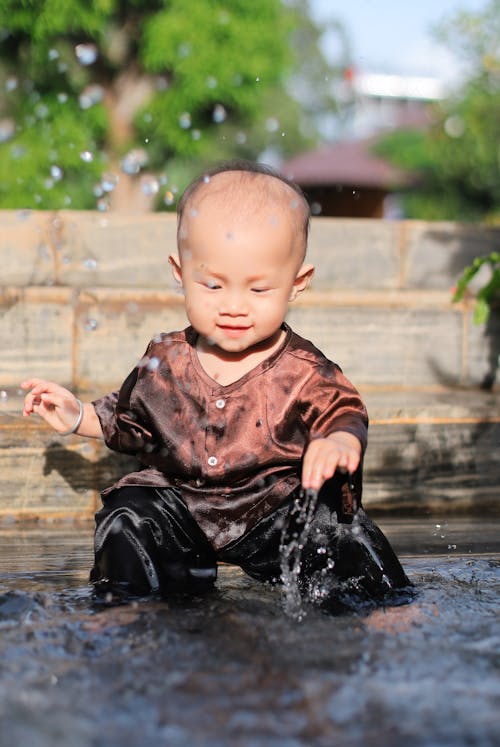 Close-up of a Cute Boy Playing Water