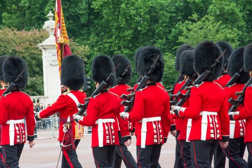 Free British Queen's Guards march with rifles during a Buckingham Palace ceremony. Stock Photo