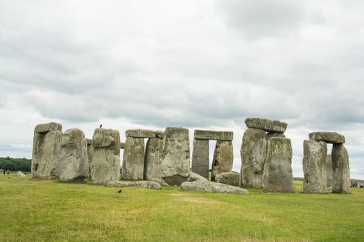 Stonehenge with a cloudy sky setting in Wiltshire, England.