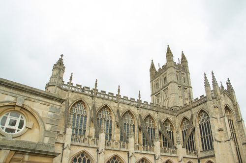 Free A captivating view of Bath Abbey's Gothic architecture under an overcast sky. Stock Photo
