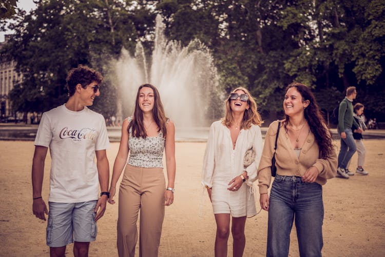 A Group Of Friends Walking At The Park While Having Fun