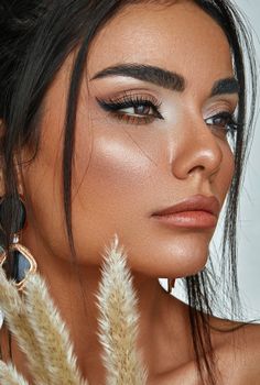 A stunning close-up portrait highlighting the woman's elegant makeup and natural beauty.