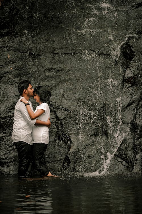 A Couple Romantic Moment Under a Waterfall