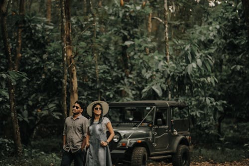 A Couple Standing in Front of Black Jeep Wrangler