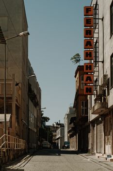 A city street with distinctive 'FERAH HAN' signage under a clear blue sky.