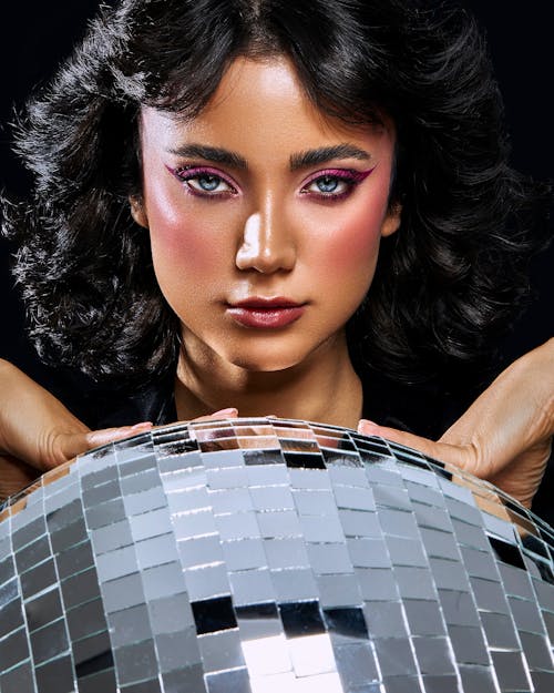 A Woman Posing with Disco Ball