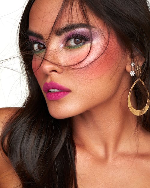 A Beautiful Woman Wearing Gold Earring Looking at the Camera