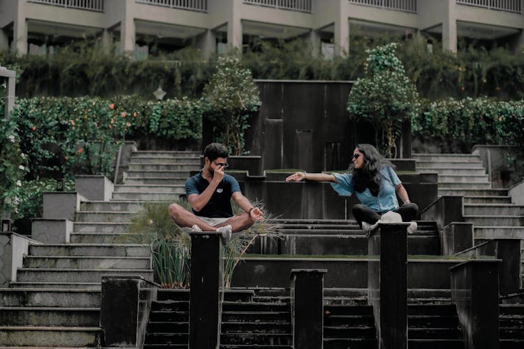 Woman And Man Sitting In Garden