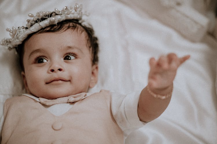 A Baby Wearing A Crown