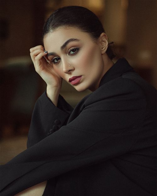 Free A sophisticated portrait showcasing a woman in a black suit with exquisite makeup, highlighting elegance and style. Stock Photo