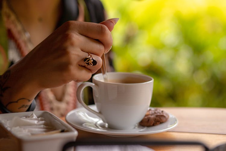 A Person Mixing White Ceramic Cup