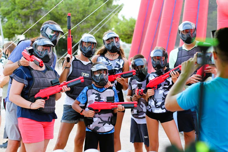 A Man Taking Photos Of A Paintball Team