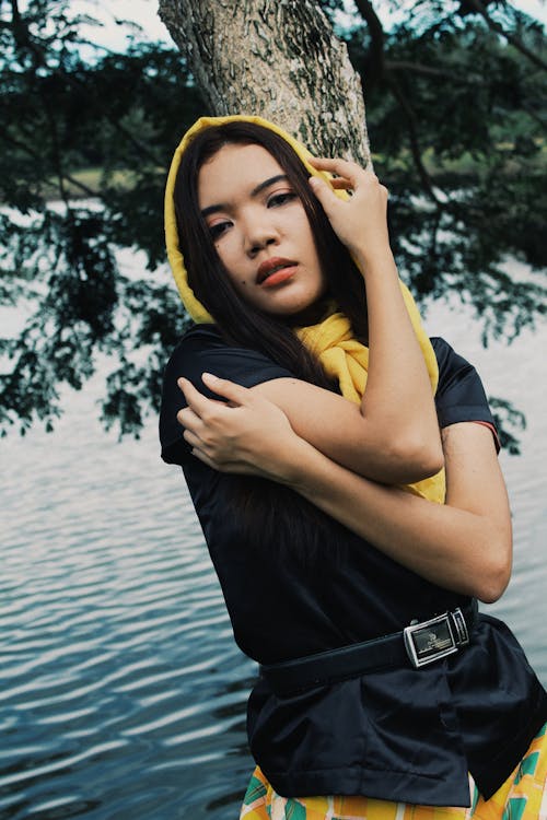 Woman in Yellow Hijab Leaning on a Tree