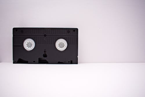 Black And White Vhs Tape On White Wooden Surface