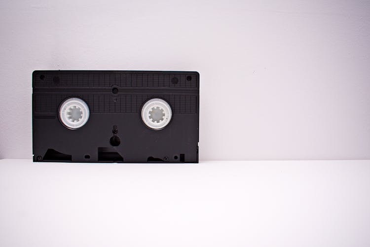 Black And White Vhs Tape On White Wooden Surface