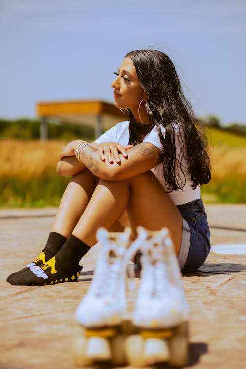 A Woman Sitting on Concrete Floor