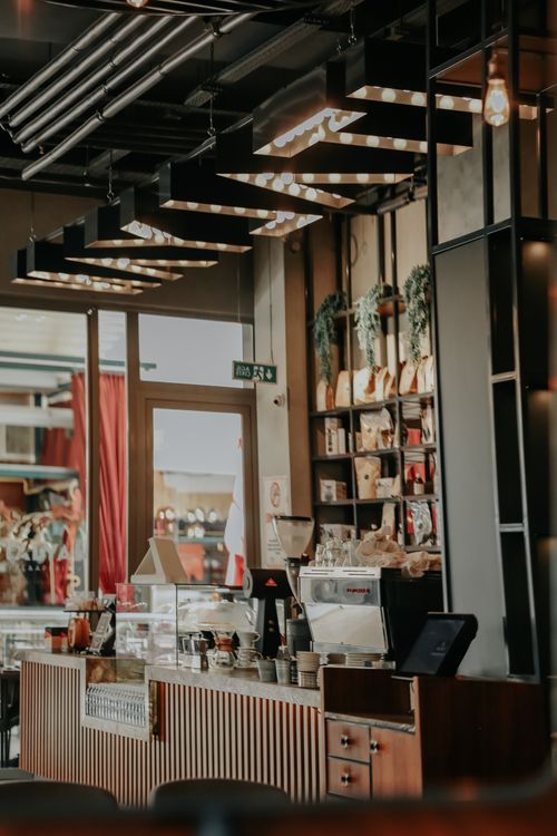 Free Cozy coffee shop interior showcasing modern design and inviting atmosphere, perfect for coffee lovers and gatherings. Stock Photo