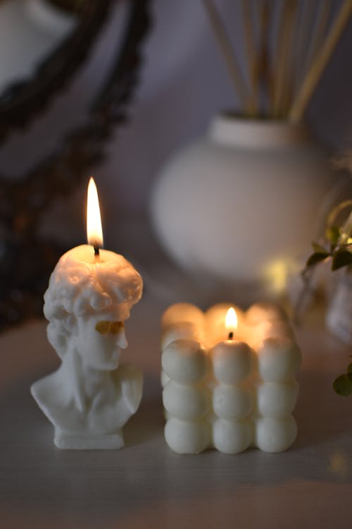 Close-Up Shot of White Lighted Candles