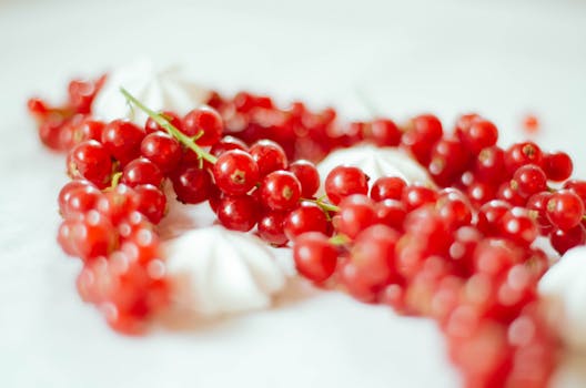Vibrant red currants with white meringues, providing a fresh and nutritious look.