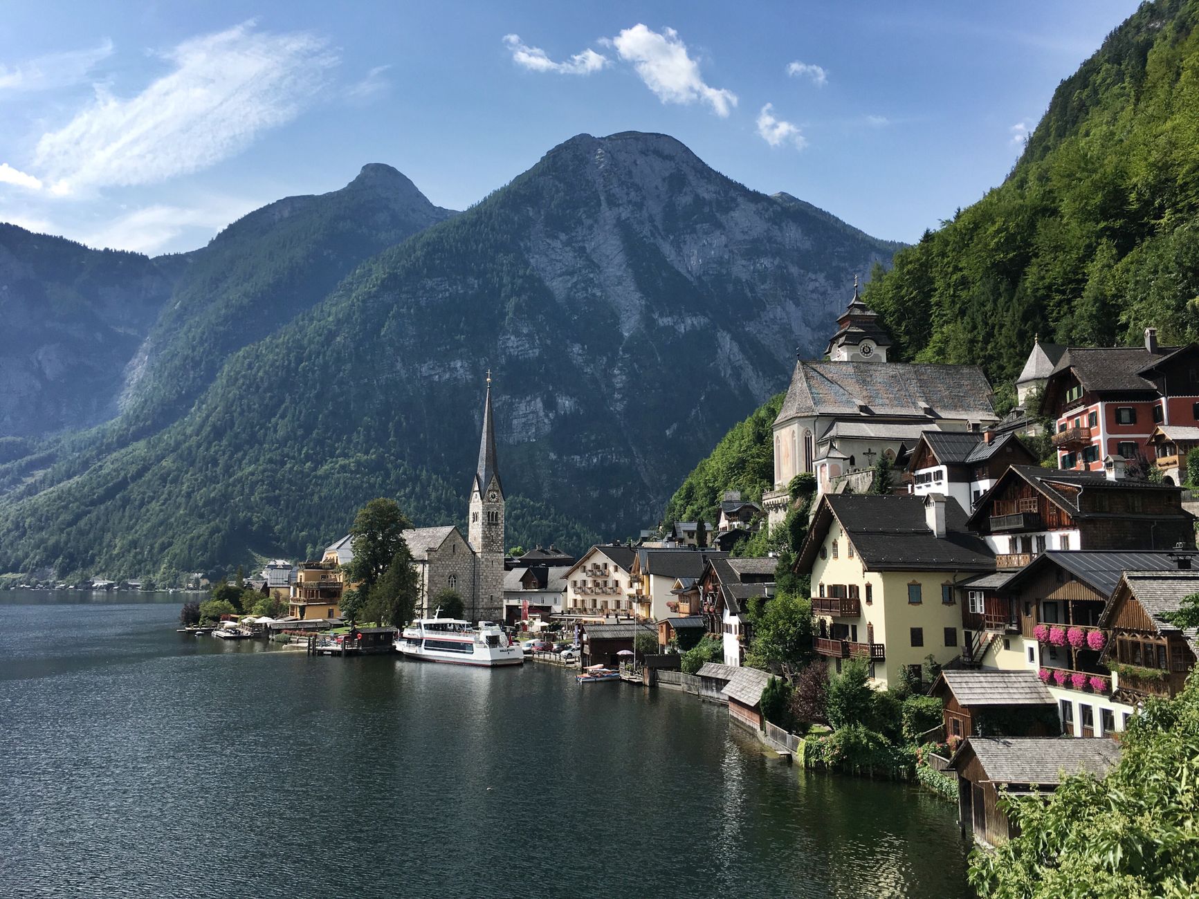 Scenic village of Hallstatt nestled by the lake with stunning mountain backdrop.