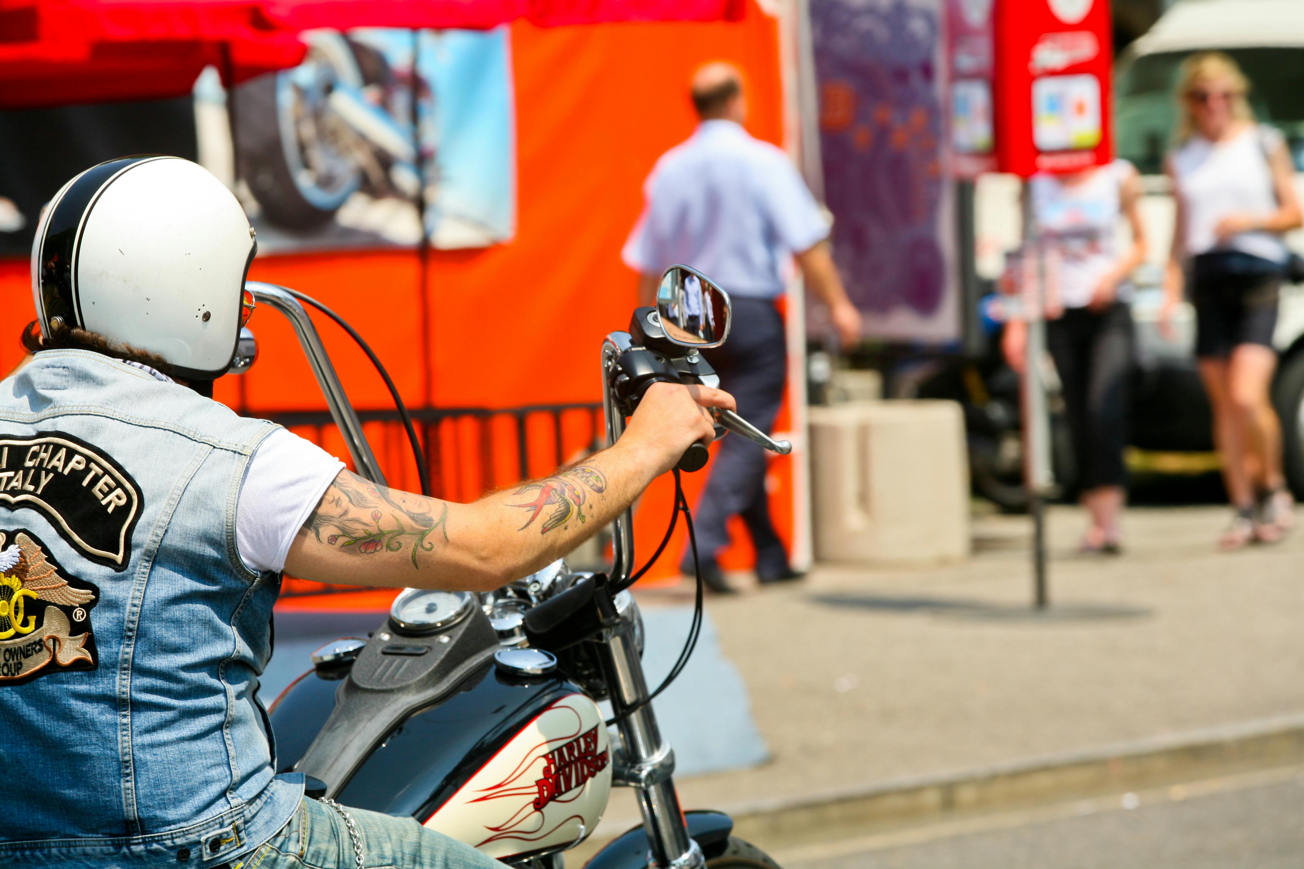 motorcycle couple holding hands