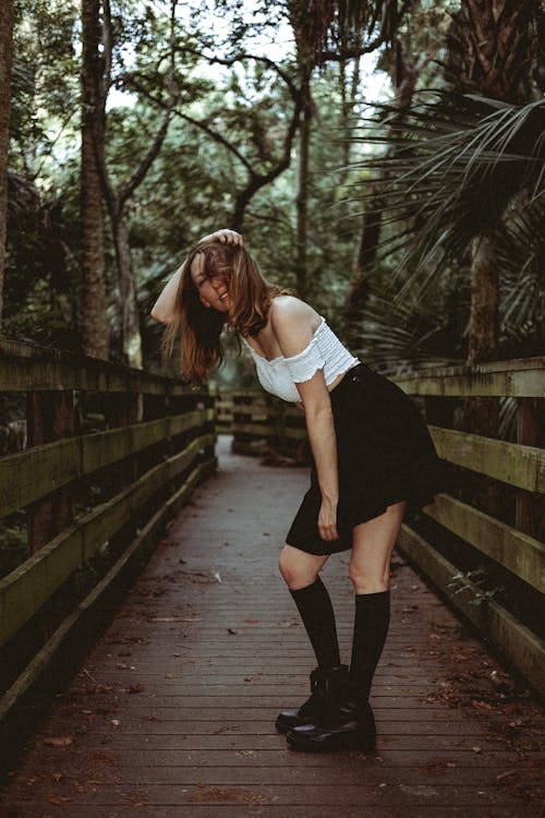 A Woman in White Crop Top and Black Skirt