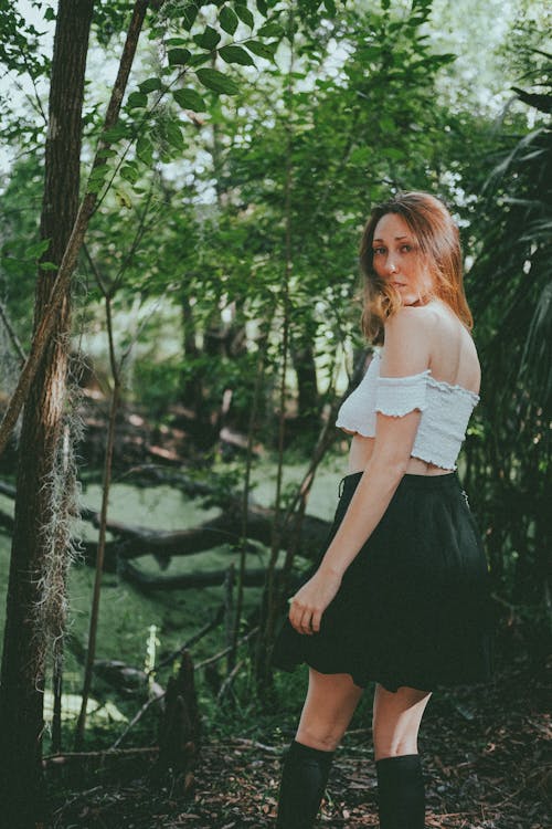 A Woman in White Off Shoulder Top Looking Over Shoulder