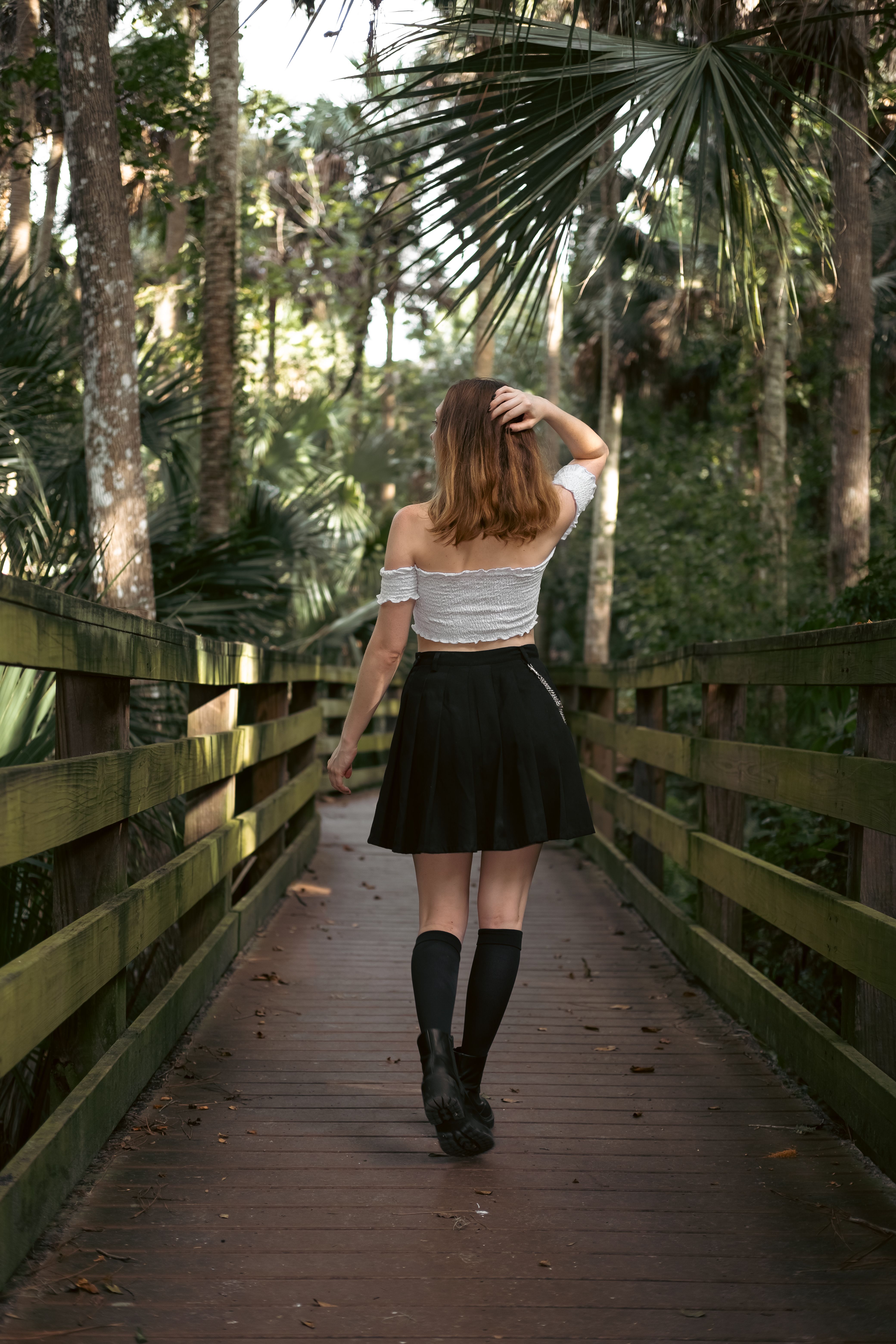 A Back View of a Woman Wearing Black Skirt · Free Stock Photo