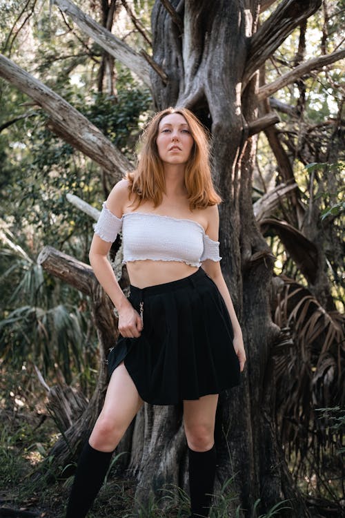 Woman in White Crop Top and Black Skirt