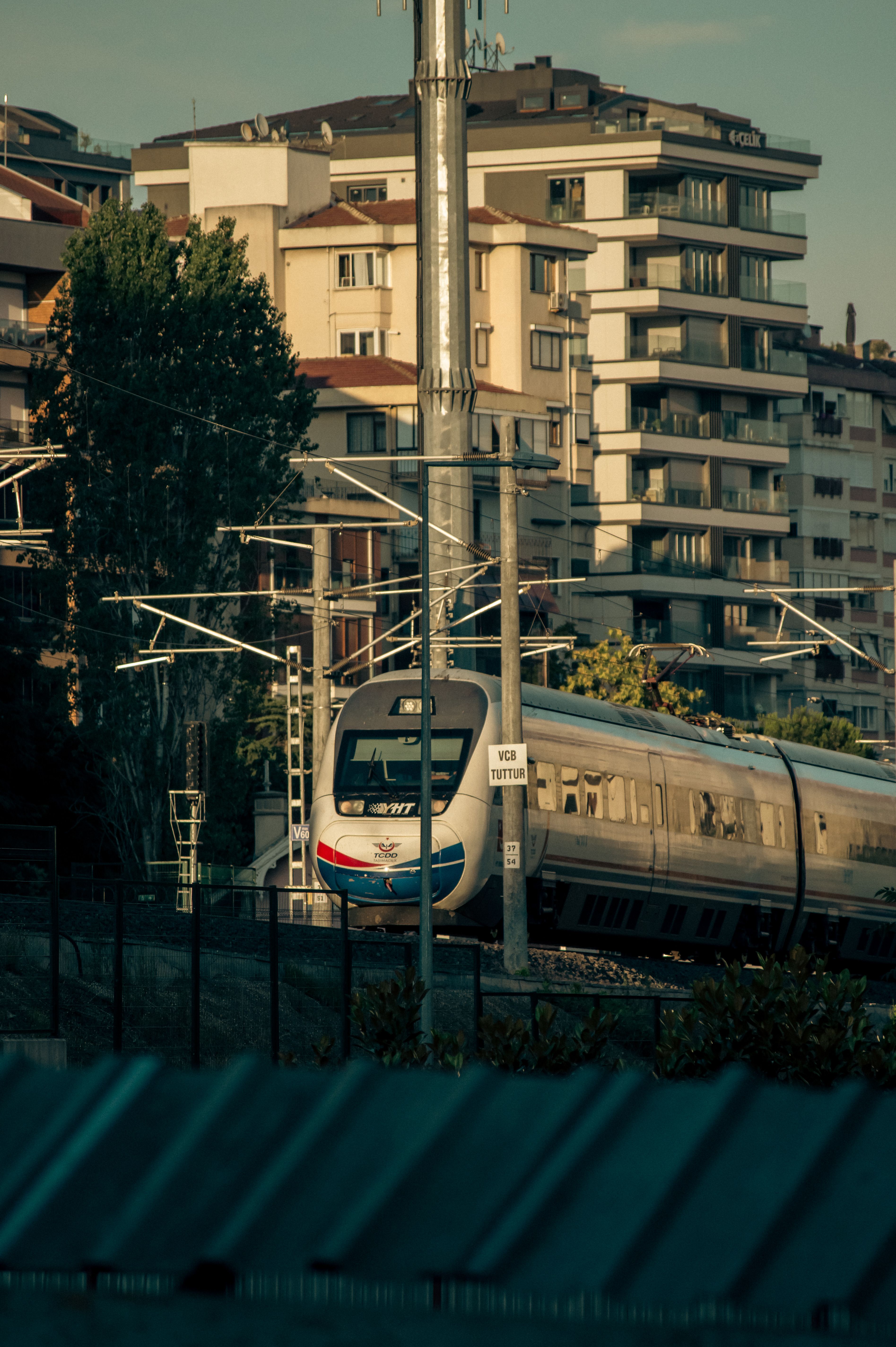 High-speed train gliding through a city landscape, showcasing urban transportation.