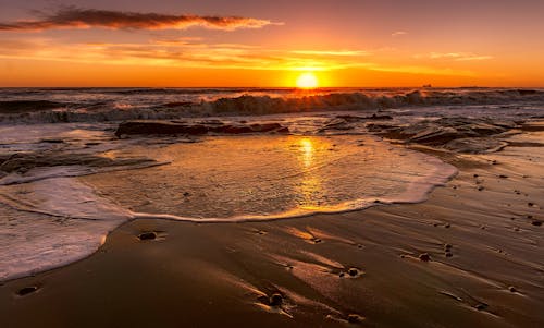 Waves Crashing on the Shore during Sunset