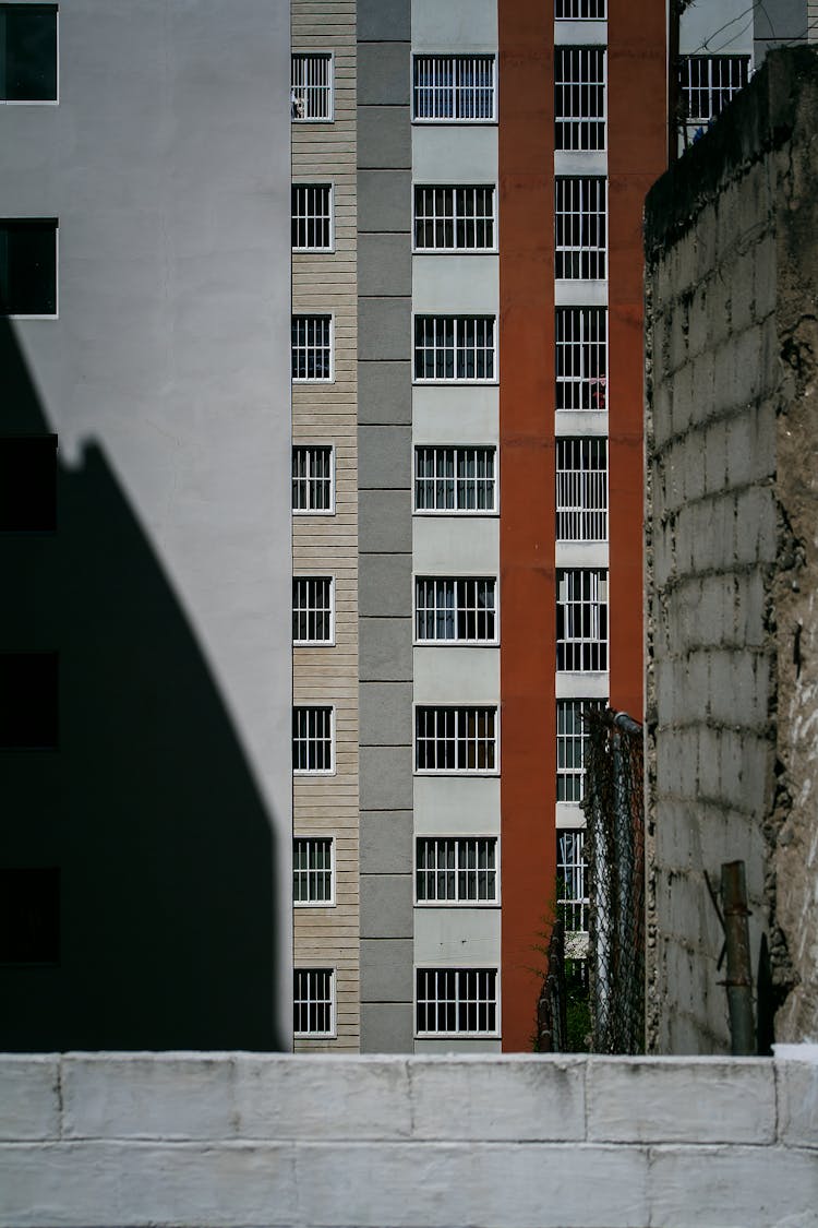 Grilled Windows Of Tall Apartment Buildings 