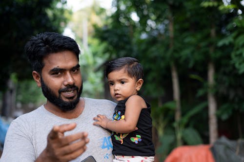 Bearded Man Carrying a Child