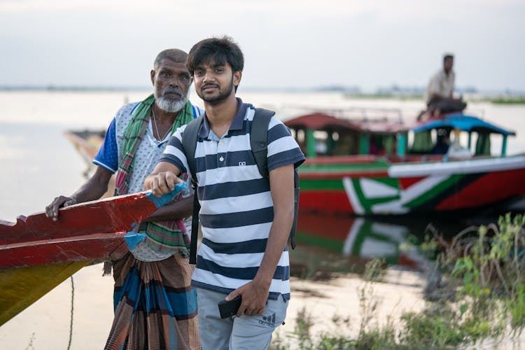 Men Holding On A Boat