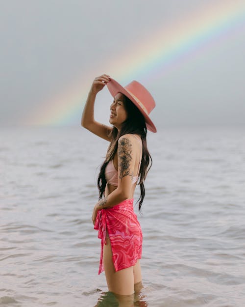A Woman in Pink Skirt Standing on the Beach