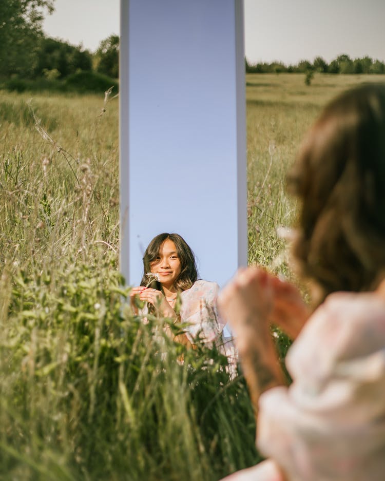 A Woman Looking In The Mirror