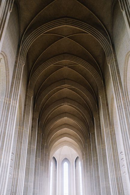 Capture the breathtaking symmetry of a neo-Gothic church interior with vaulted arches and majestic pillars.