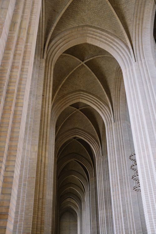 Free Captivating low-angle view of the intricate gothic arched ceiling in a grand cathedral. Stock Photo