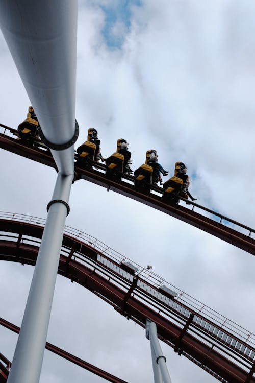 People Riding a Rollercoaster in an Amusement Park