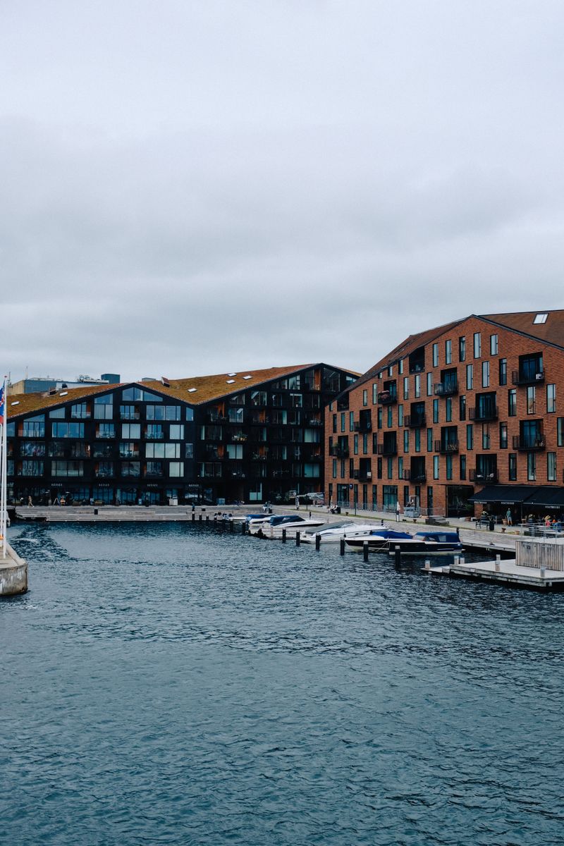 Brick apartment buildings along a Copenhagen canal — photo by Adrien Olichon on Pexels