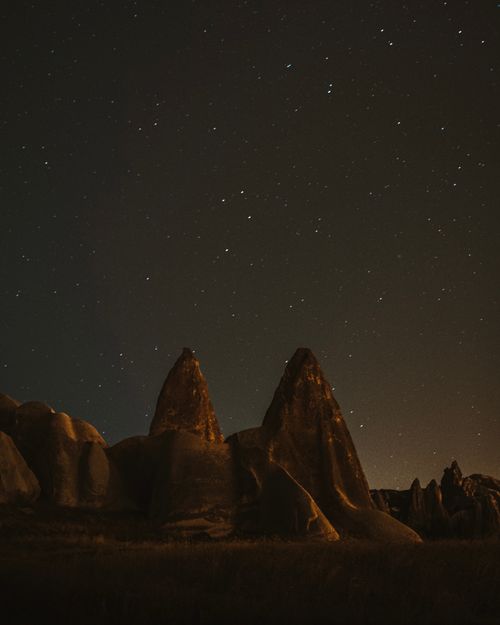 Free Explore the night sky with stunning rock formations in Cappadocia, Turkey. A breathtaking travel destination. Stock Photo