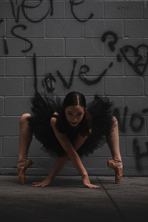 Free Ballet dancer in black dress poses against graffiti wall, Orlando. Stock Photo